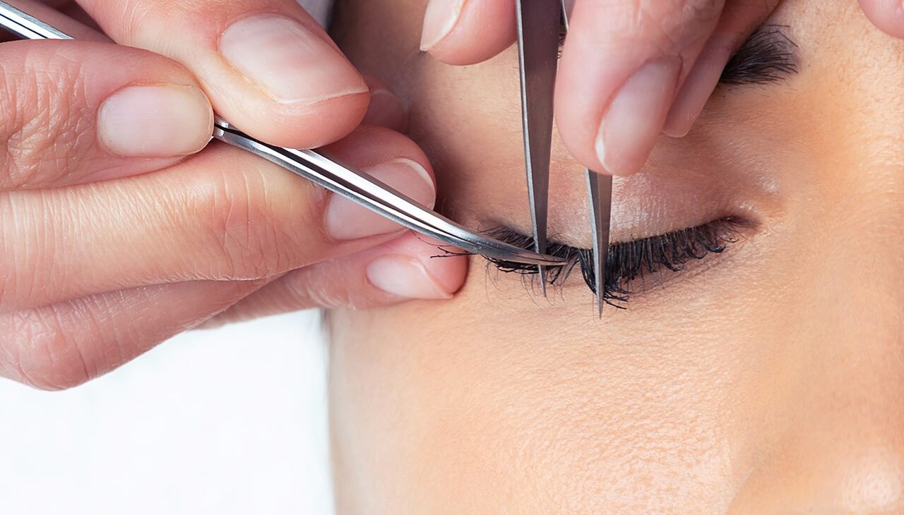shot-cosmetologist-doing-eyelash-extension-procedure-woman-white-background shot-cosmetologist-doing-eyelash-extension-procedure-woman-white-background